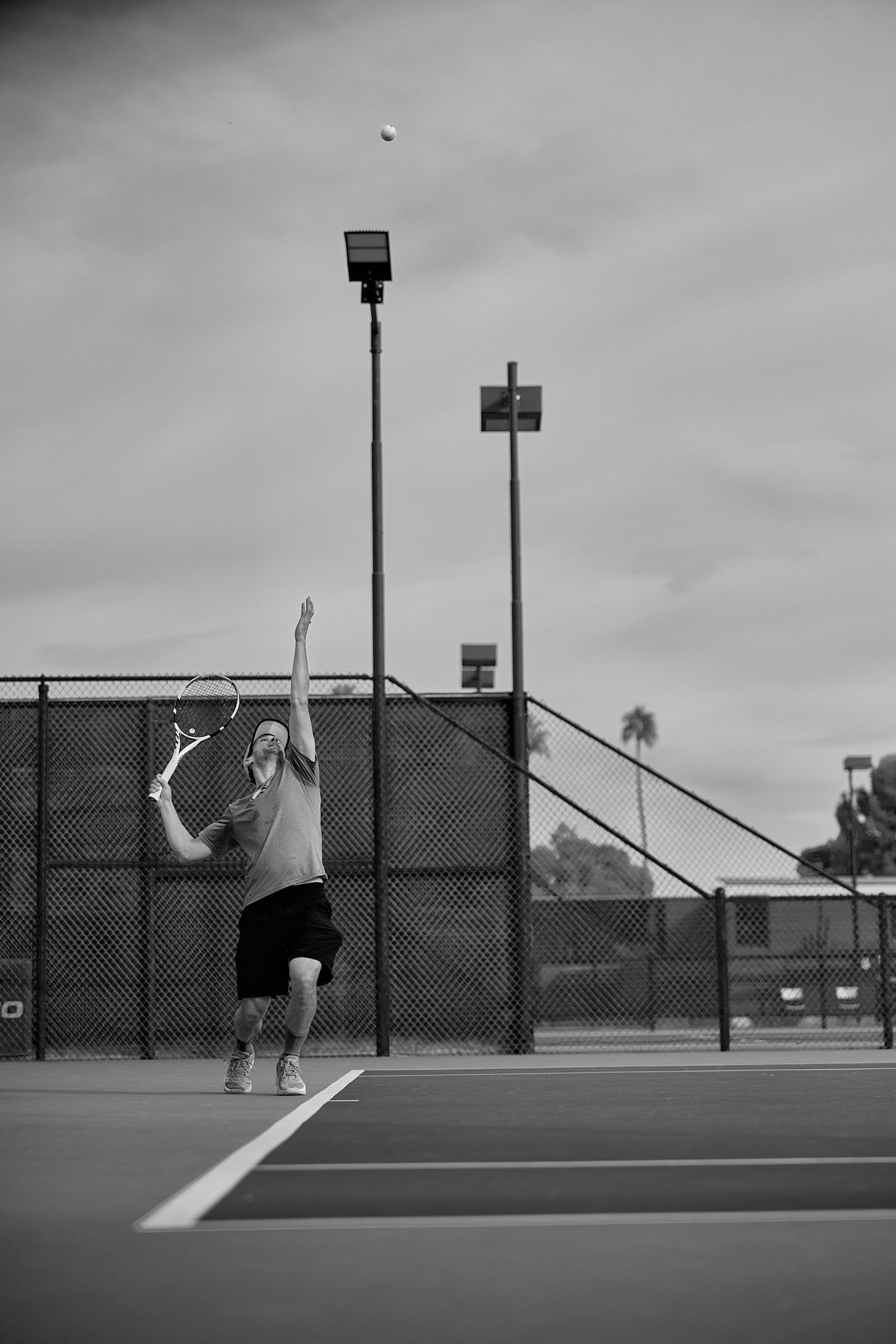 Court lights against the sky at CC Tennis Club
